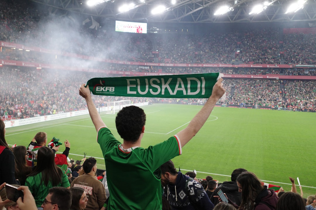 Manchester United rivalry - Fan holds up euskadi scarf in stadium crowd