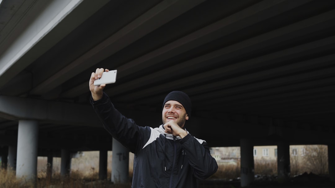why hailey baptiste retired - Man taking a selfie under a bridge.