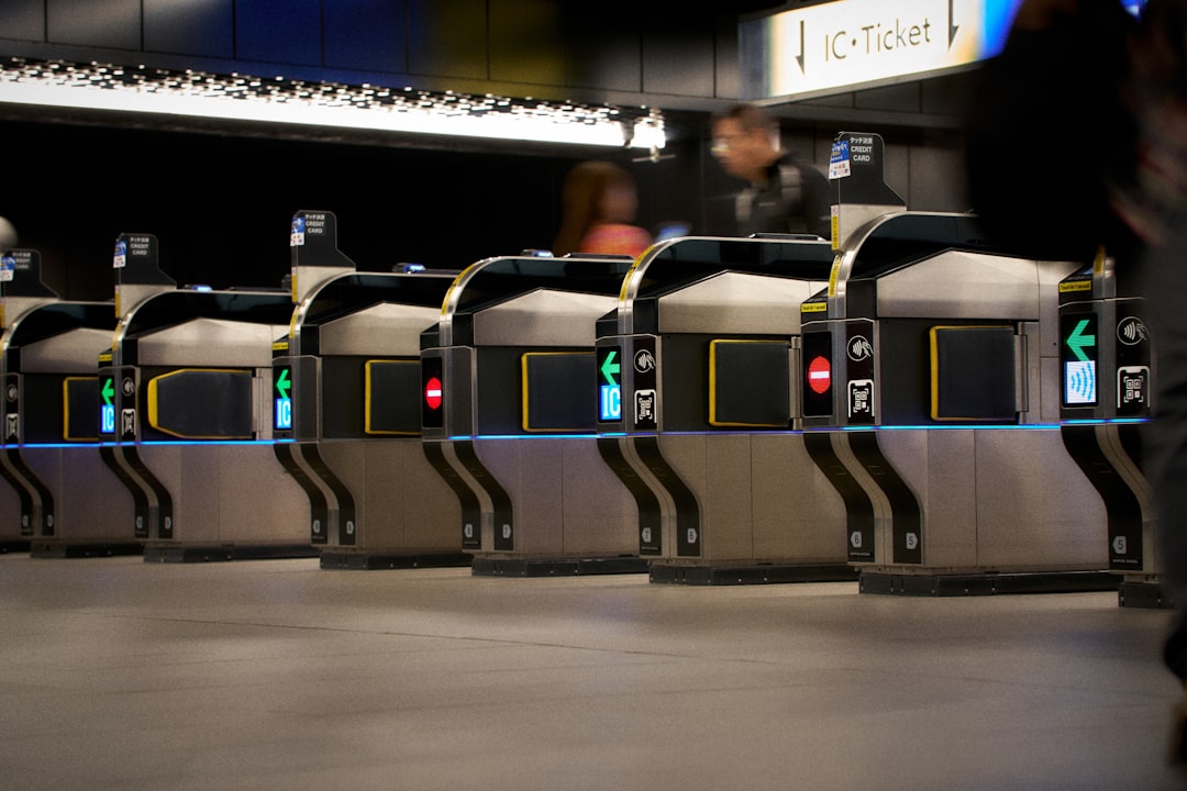 why omny card not accepted - Row of ticket gates in a modern subway station